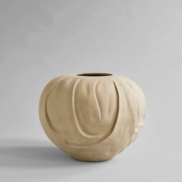 Beige ceramic vase on a gray background from 101 Copenhagen at Spacio retail stores in Mumbai & Kolkata. 