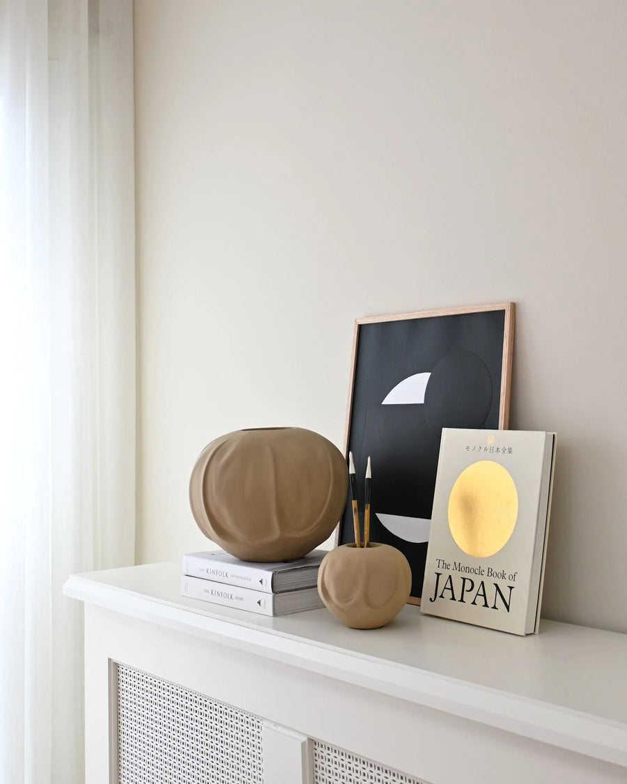 Decorative items on a white shelf against a light wall from 101 Copenhagen at Spacio retail stores in Mumbai & Kolkata. 