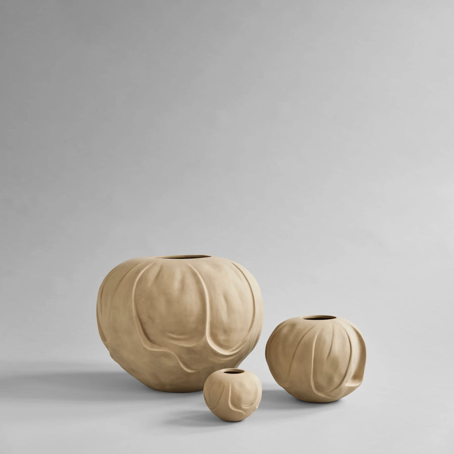 Three beige ceramic vases of different sizes on a light gray background from 101 Copenhagen at Spacio retail stores in Mumbai & Kolkata. 