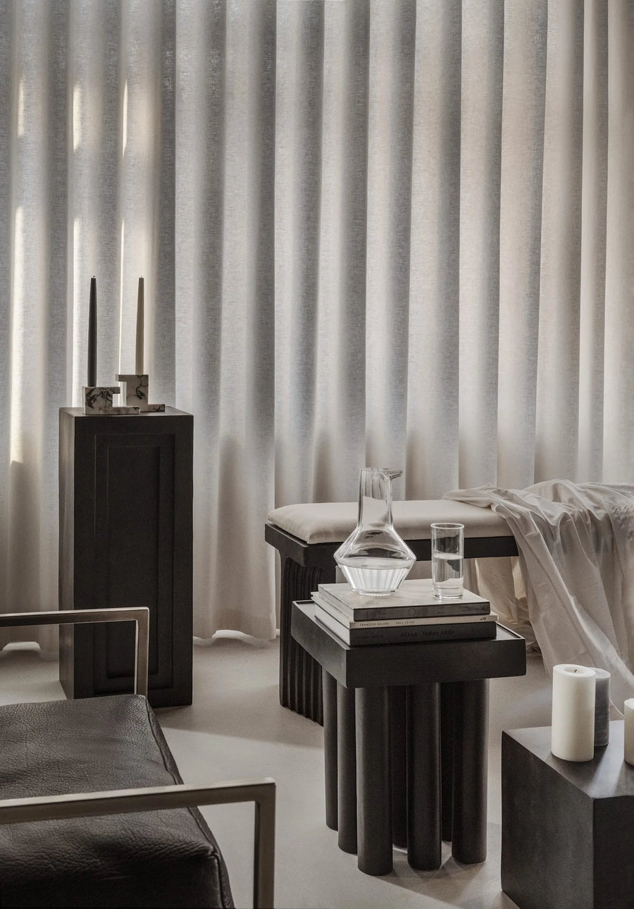 Modern interior with dark furniture and light curtains from 101 Copenhagen