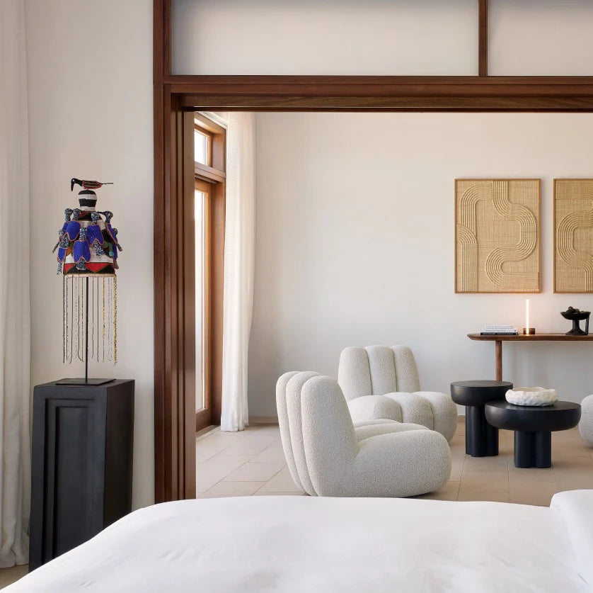 Modern bedroom with white furniture, decorative lamp, and wall art from 101 Copenhagen