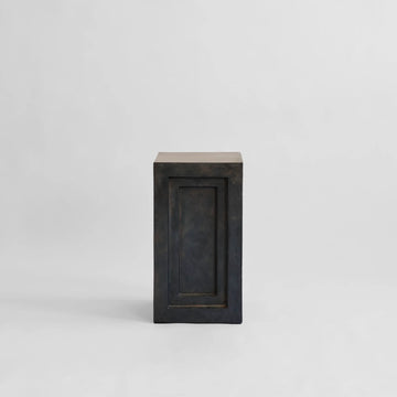 Rectangular pedestal plinth with a coffee colour finish on a light gray background from 101 Copenhagen at Spacio retail stores in Mumbai & Kolkata. 