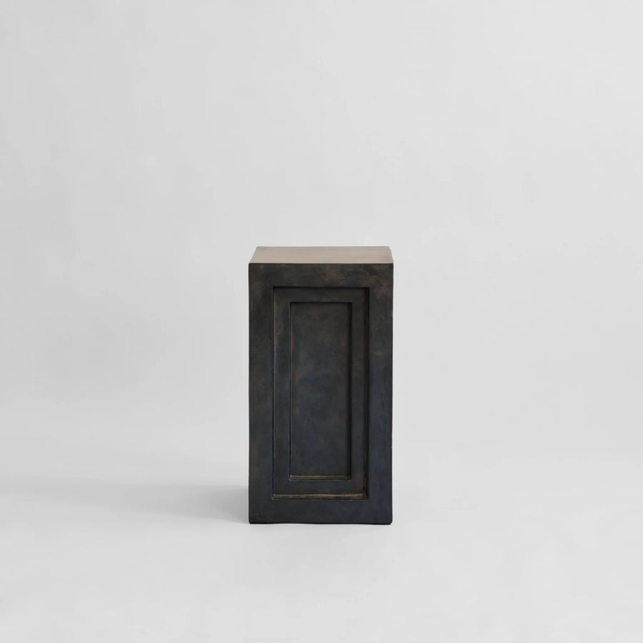 Rectangular pedestal plinth with a coffee colour finish on a light gray background from 101 Copenhagen at Spacio retail stores in Mumbai & Kolkata. 