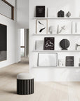 A white and black living room with shelves and a stool, featuring Scandinavian brand furniture and accents including the 101 Copenhagen Sphere Bubl Mini Dark Grey 111029.