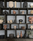 A shelf full of various Scandinavian brand vases and pots, including the 101Cph Sphere Bubl Mini Sand 203008 with a sand finish from 101 Copenhagen.