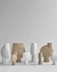 A group of 101Cph Sphere Bubl Shisen Big B White 231013 vases in various shapes and sizes, featuring a Bone White finish. These vases are decorative and sculptural in a 101 Copenhagen manner.