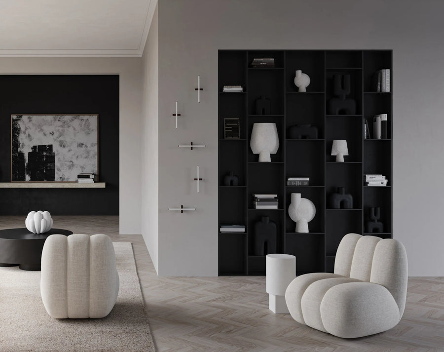 A black and white living room with white furniture featuring a 101Cph Sphere Bubl Shisen Big B White 231013 finish from the brand 101 Copenhagen. The furniture is arranged in a decorative and sculptural manner, creating an atmosphere of modern elegance. SEO keywords: Sphere