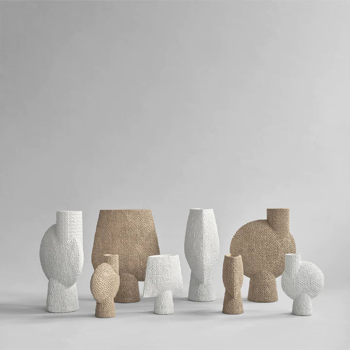 A collection of 101Cph Sphere Square Shisen Big Bone White 231011 decorative and sculptural vases in various shapes and sizes, featuring a unique detailed finish, by 101 Copenhagen.