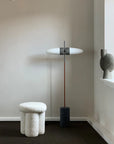 A 101 Copenhagen brand room with a 101Cph Sphere Vase Bubl Big Dark Grey 201015 floor lamp and a stool.