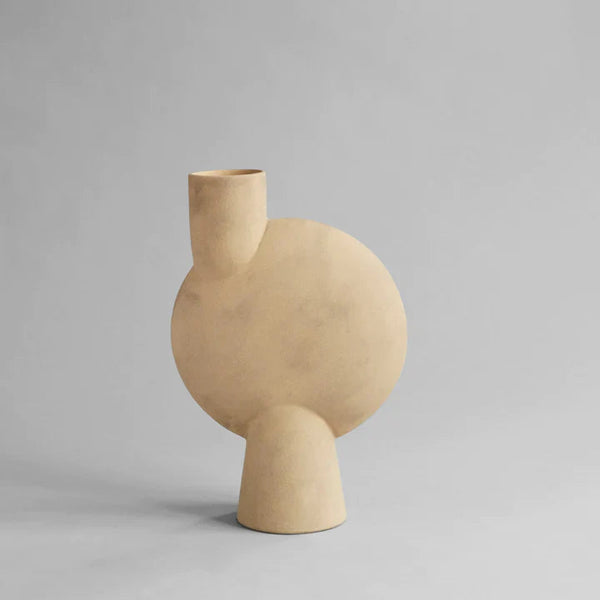 A sand finished 101Cph Sphere Vase Bubl Big Sand 201014 on a grey background.