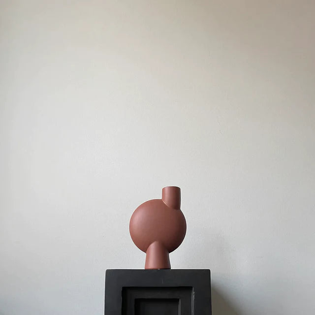 A 101Cph Sphere Vase Bubl Medio Cinnamon 221035 (Limited Edition) from 101 Copenhagen sits on top of a black box.