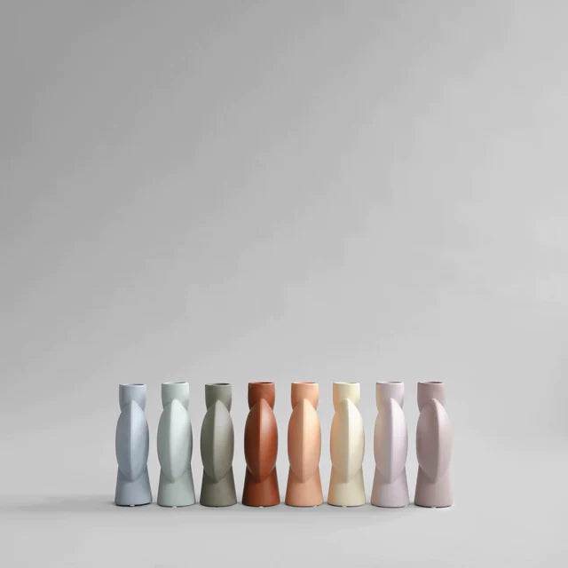 A limited edition collection of 101Cph Sphere Vase Bubl Medio Cinnamon 221035 (Limited Edition) vases in different colors, showcased on a sleek grey background by the brand 101 Copenhagen.