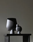 Two sculptural vase on the arc console table against a plain wall from 101 Copenhagen at Spacio retail stores in Mumbai & Kolkata. 