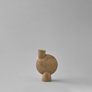 Brown ceramic vase with a unique design on a gray background from 101 Copenhagen at Spacio retail stores in Mumbai & Kolkata. 