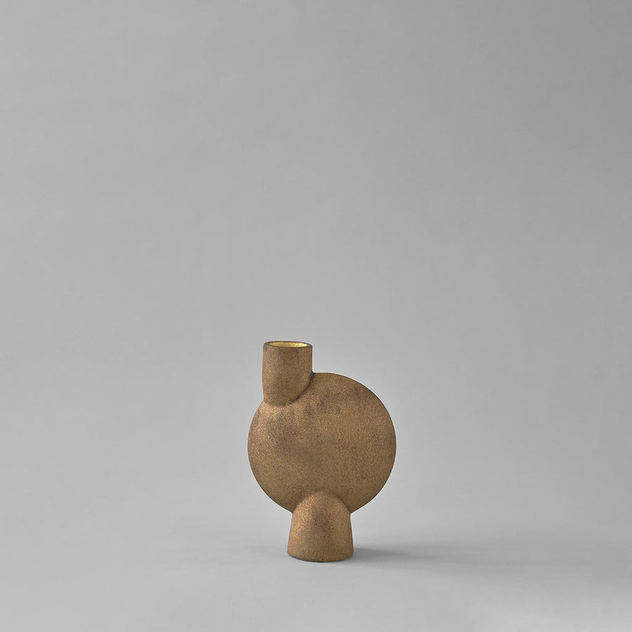Brown ceramic vase with a unique design on a gray background from 101 Copenhagen at Spacio retail stores in Mumbai & Kolkata. 