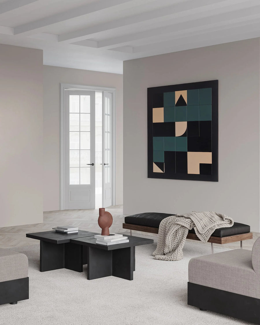 Modern living room with abstract art on the wall and minimal furniture.