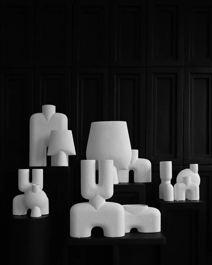 A black and white photo of a group of white sculptures showcasing the elegant designs of the Scandinavian brand, 101 Copenhagen.