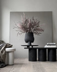 A 101Cph Sphere Vase Square Big Coffee 111183 from the 101 Copenhagen brand sits on a table in a room.