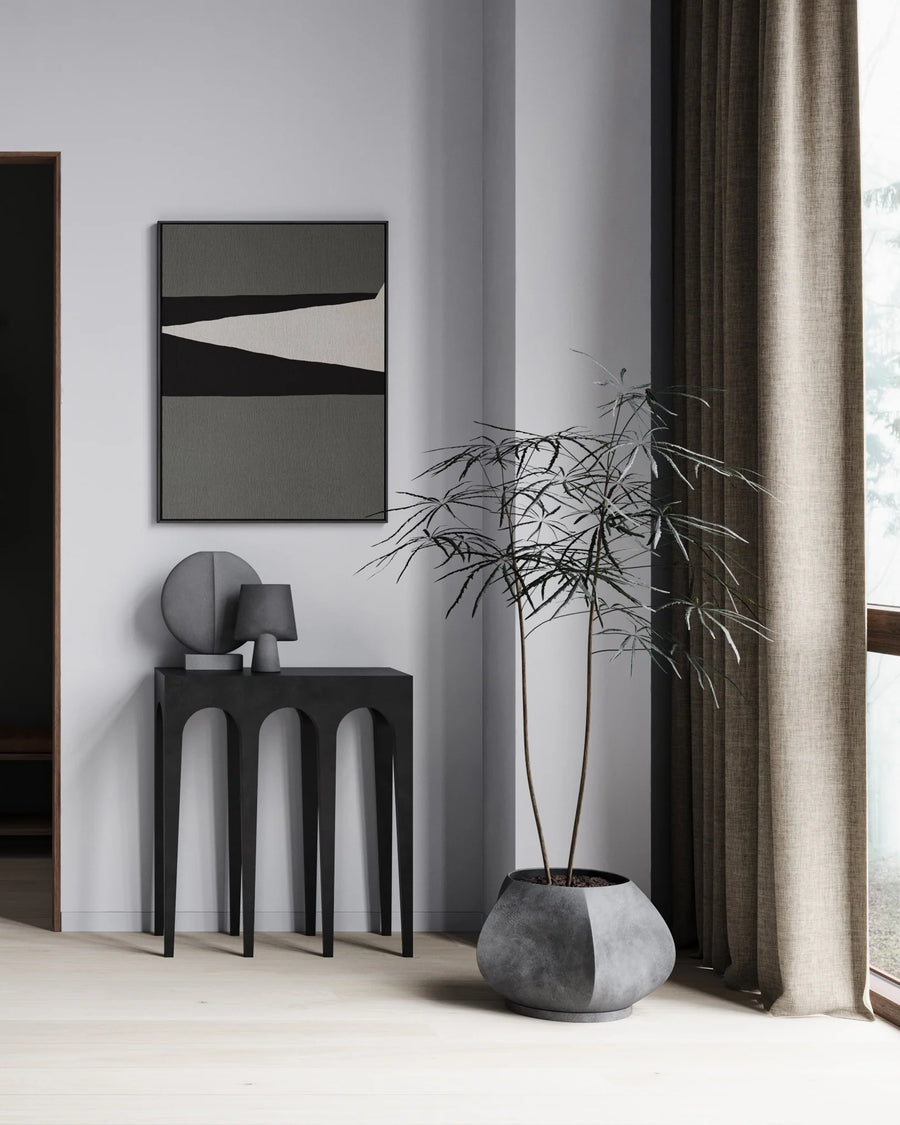 A 101 Copenhagen living room with a potted plant and the 101Cph Sphere Vase Square Mini Dark Grey 111020 from the Sphere collection.