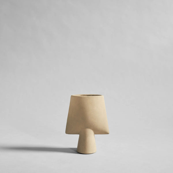 Beige ceramic sculptural vase with a plain background from 101 Copenhagen at Spacio retail stores in Mumbai & Kolkata. 
