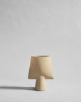 Beige ceramic sculptural vase with a plain background from 101 Copenhagen at Spacio retail stores in Mumbai & Kolkata. 