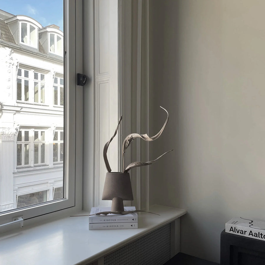 Decorative sculptural vase on a windowsill with a view of a building outside from 101 Copenhagen at Spacio retail stores in Mumbai & Kolkata. 