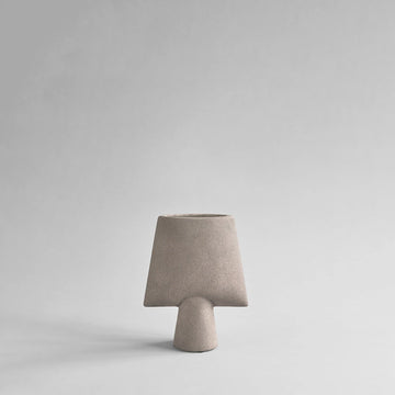 Beige ceramic vase on a light gray background from 101 Copenhagen at Spacio retail stores in Mumbai & Kolkata. 