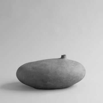 Gray ceramic vase on a light gray background from 101 Copenhagen at Spacio retail stores in Mumbai & Kolkata. 