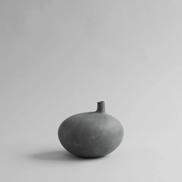 Gray ceramic vase on a light gray background from 101 Copenhagen at Spacio retail stores in Mumbai & Kolkata. 