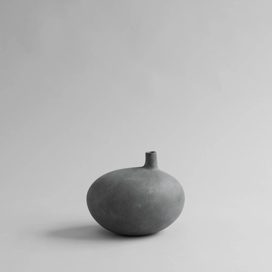 Gray ceramic vase on a light gray background from 101 Copenhagen at Spacio retail stores in Mumbai & Kolkata. 