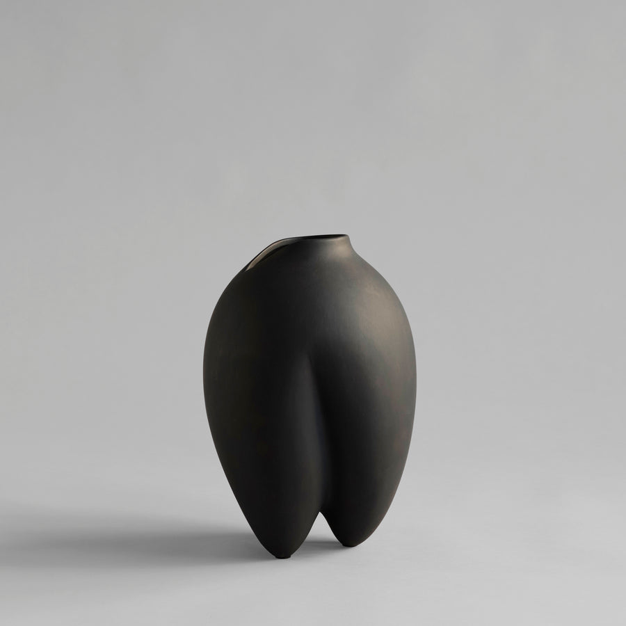 Black vase on a gray background from 101 Copenhagen at Spacio retail stores in Mumbai & Kolkata. 