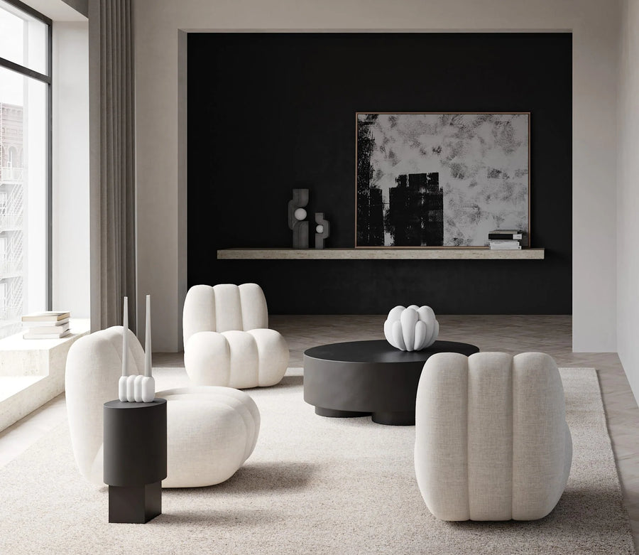 Modern living room with white armchairs and a black coffee table.