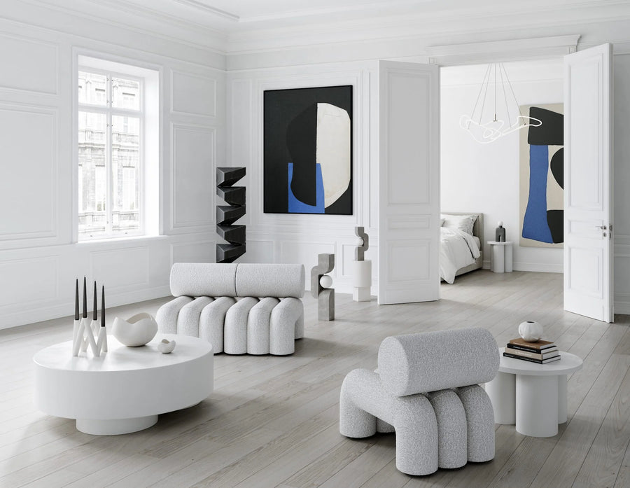 Modern living room with white furniture and abstract art