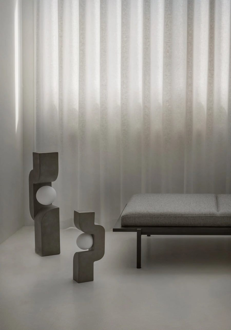 Modern interior with abstract sculptures and a bench against a textured wall from 101 Copenhagen at Spacio retail stores in Mumbai & Kolkata. 