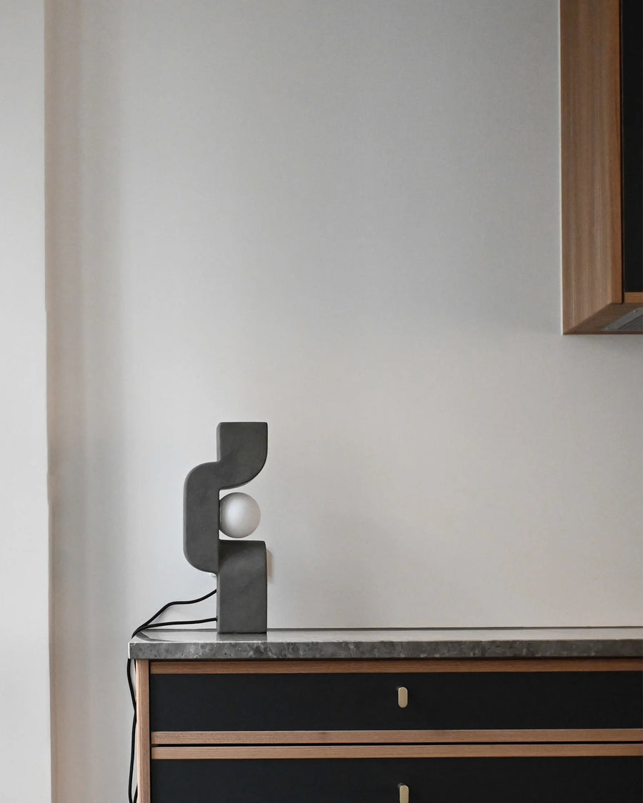 Modern lamp on a sideboard against a plain wall from 101 Copenhagen at Spacio retail stores in Mumbai & Kolkata. 