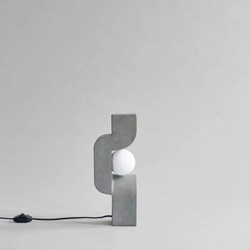 Modern wall lamp with concrete-like finish on a light gray background from 101 Copenhagen at Spacio retail stores in Mumbai & Kolkata. 