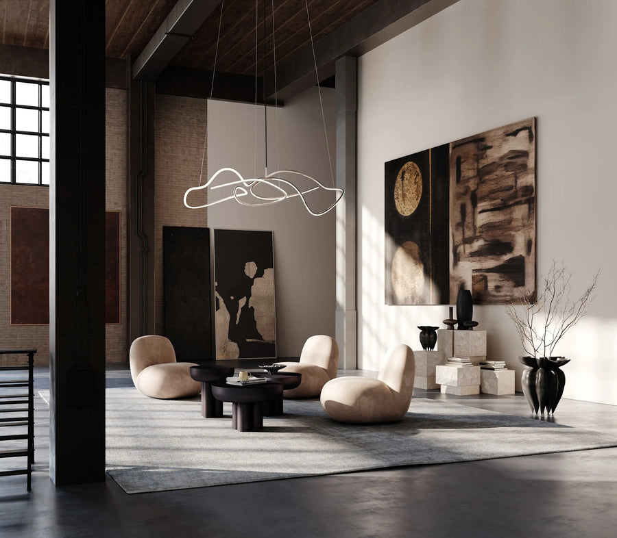Modern living room with abstract art, stylish furniture, and a hanging light fixture.