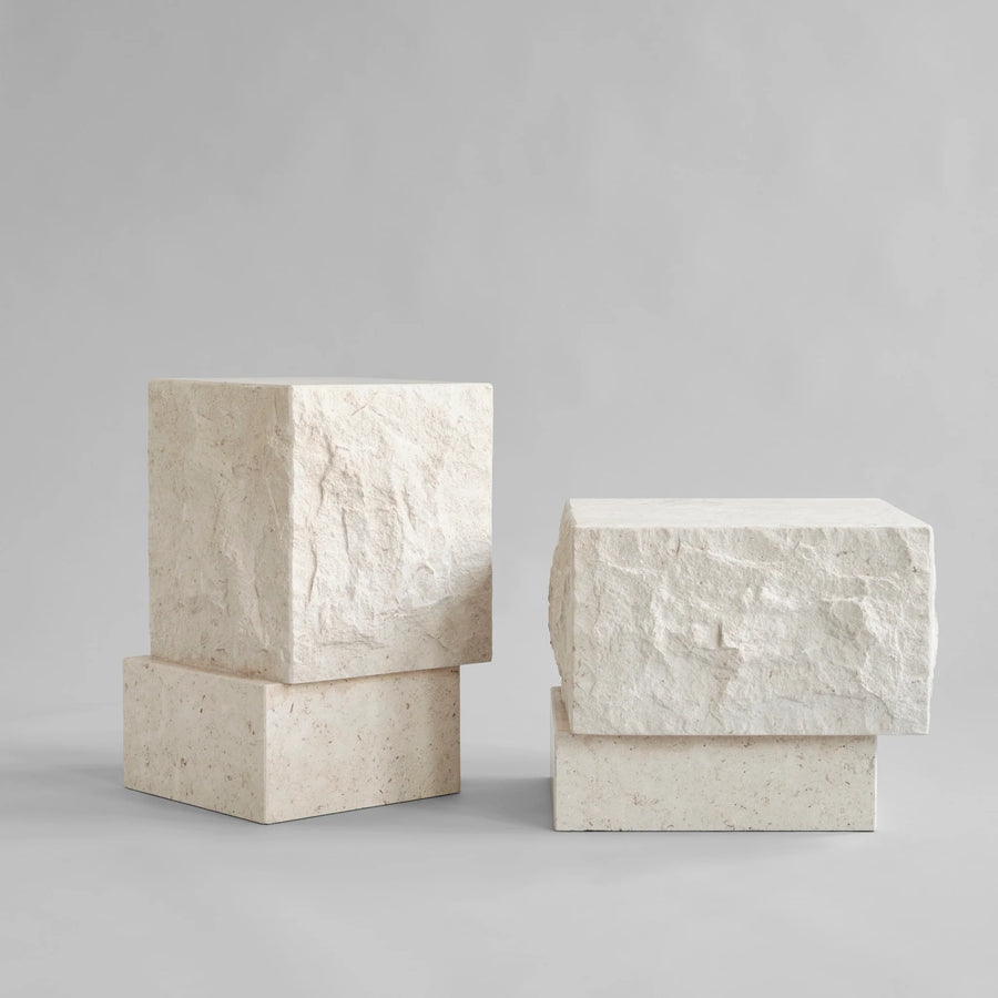 Pair of high and low rectangular limestone plinth on a gray background from 101 Copenhagen at Spacio retail stores in Mumbai & Kolkata. 