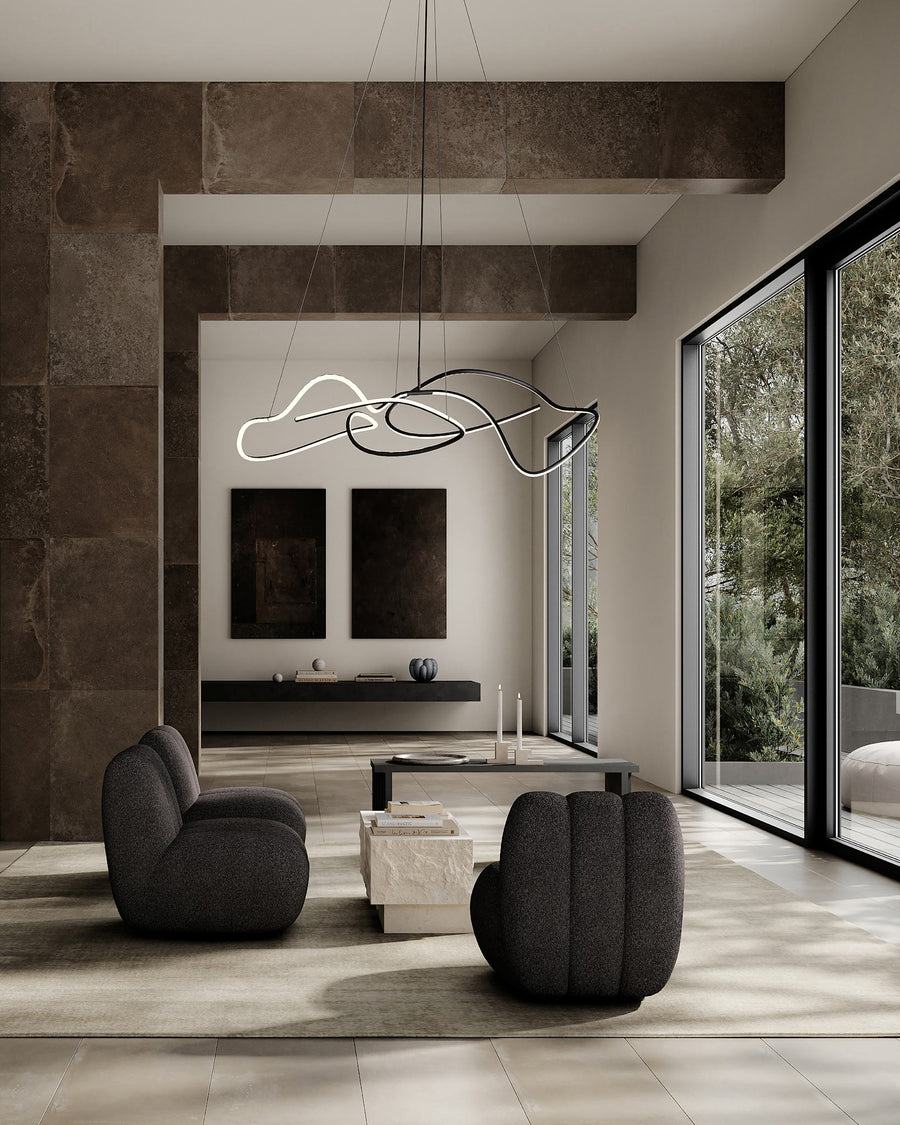 Modern living room with gray chairs, a coffee table, and a stylish chandelier.