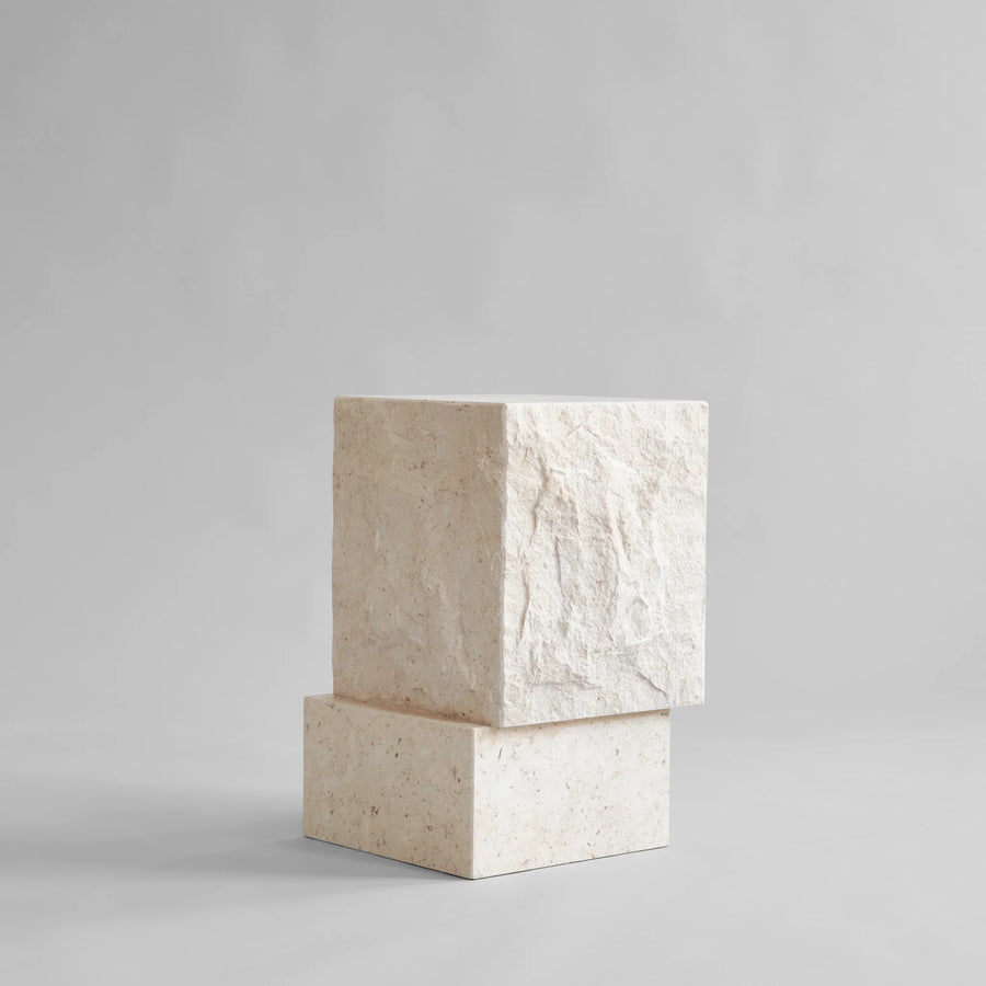 Side view of a tall limestone plinth from 101 Copenhagen at Spacio retail stores in Mumbai & Kolkata. 