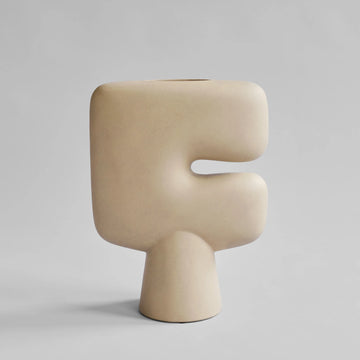 Beige sculptural vase in a light gray background from 101 Copenhagen at Spacio retail stores in Mumbai & Kolkata. 
