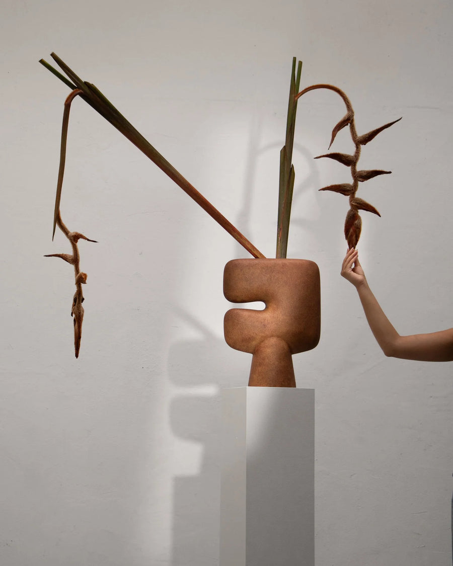 Abstract sculptural vase with organic shapes and natural elements on a white background from 101 Copenhagen at Spacio retail stores in Mumbai & Kolkata. 