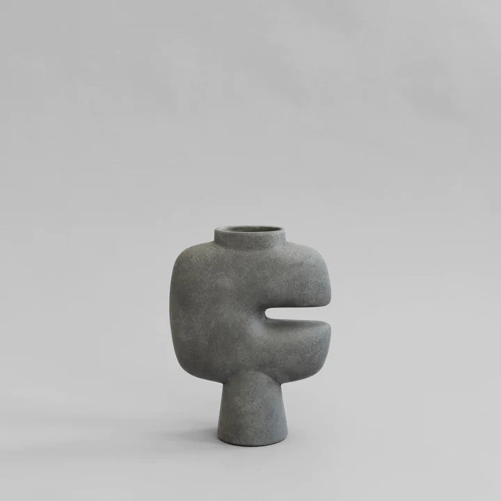 A 101Cph Tribal Vase Medio Dark Grey 214003 with a curved shape on a white background. Available at Spacio India