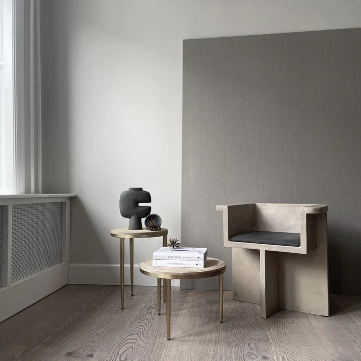 A dark grey room with a chair and a table, featuring a 101Cph Tribal Vase Medio Dark Grey 214003 from the 101 Copenhagen tribal collection.  Available at Spacio India