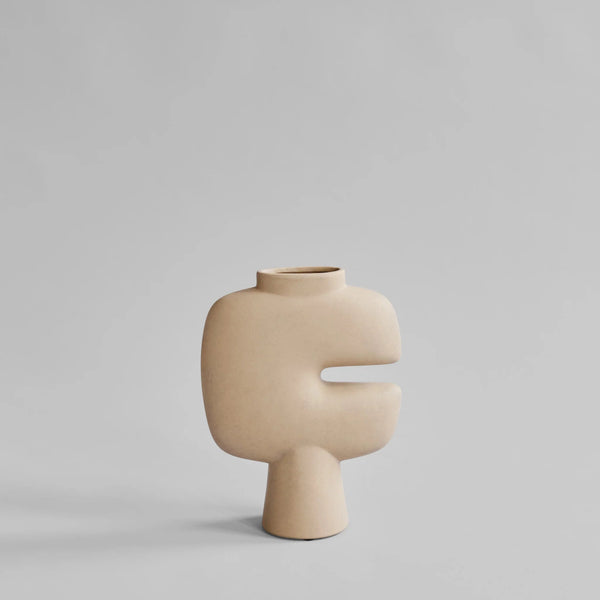 Beige ceramic vase with a unique design on a light gray background from 101 Copenhagen at Spacio retail stores in Mumbai & Kolkata. 