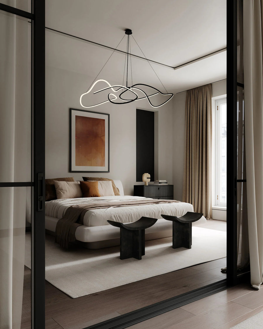Modern bedroom with a bed, side tables, and abstract wall art.