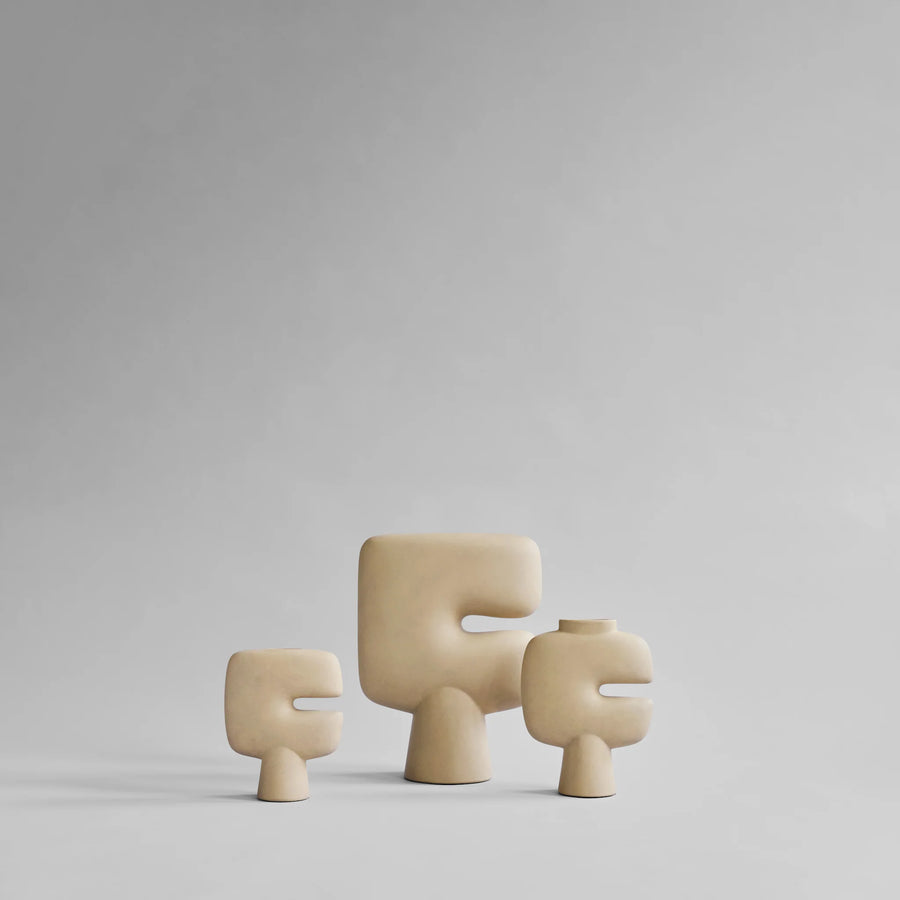 Three beige ceramic sculptural vases on a light gray background from 101 Copenhagen at Spacio retail stores in Mumbai & Kolkata. 