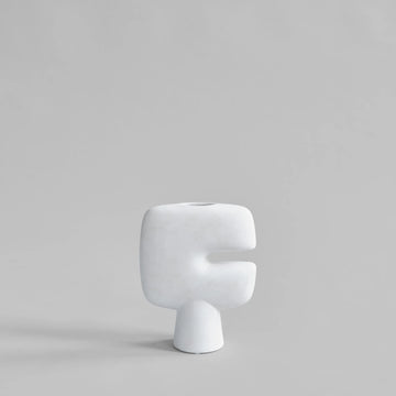 White ceramic vase on a gray background  from 101 Copenhagen at Spacio retail stores in Mumbai & Kolkata. 