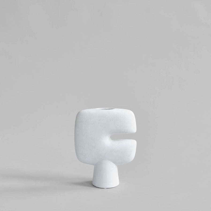 White ceramic vase on a gray background  from 101 Copenhagen at Spacio retail stores in Mumbai & Kolkata. 