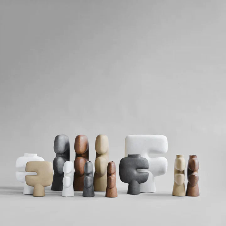 A collection of 101Cph Tribal Vase Minis in different shapes and sizes, placed on a mesmerizing grey background. Available at Spacio India